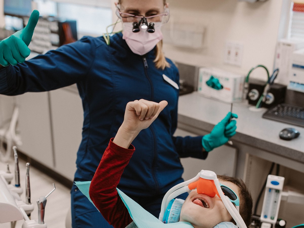 A pediatric dentist caring for a young patient